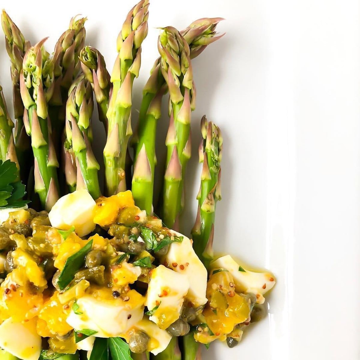 closeup of sauce gribiche with asparagus