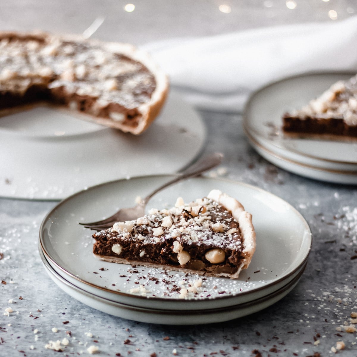 slice of chocolate macadamia nut tart on a plate