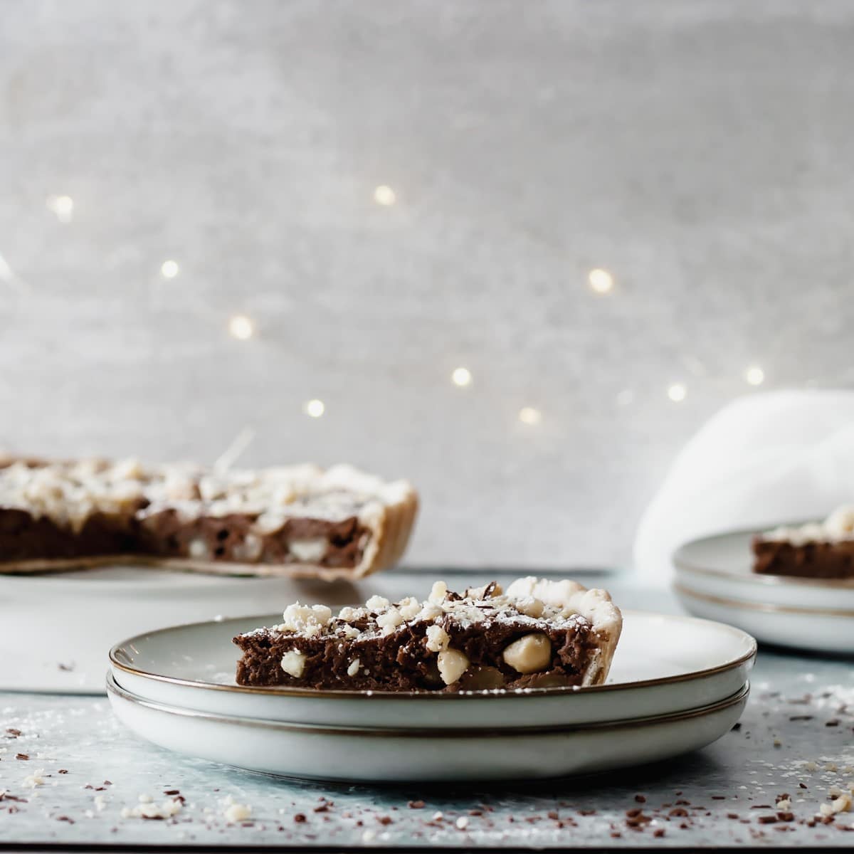 Slice of chocolate macadamia nut tart