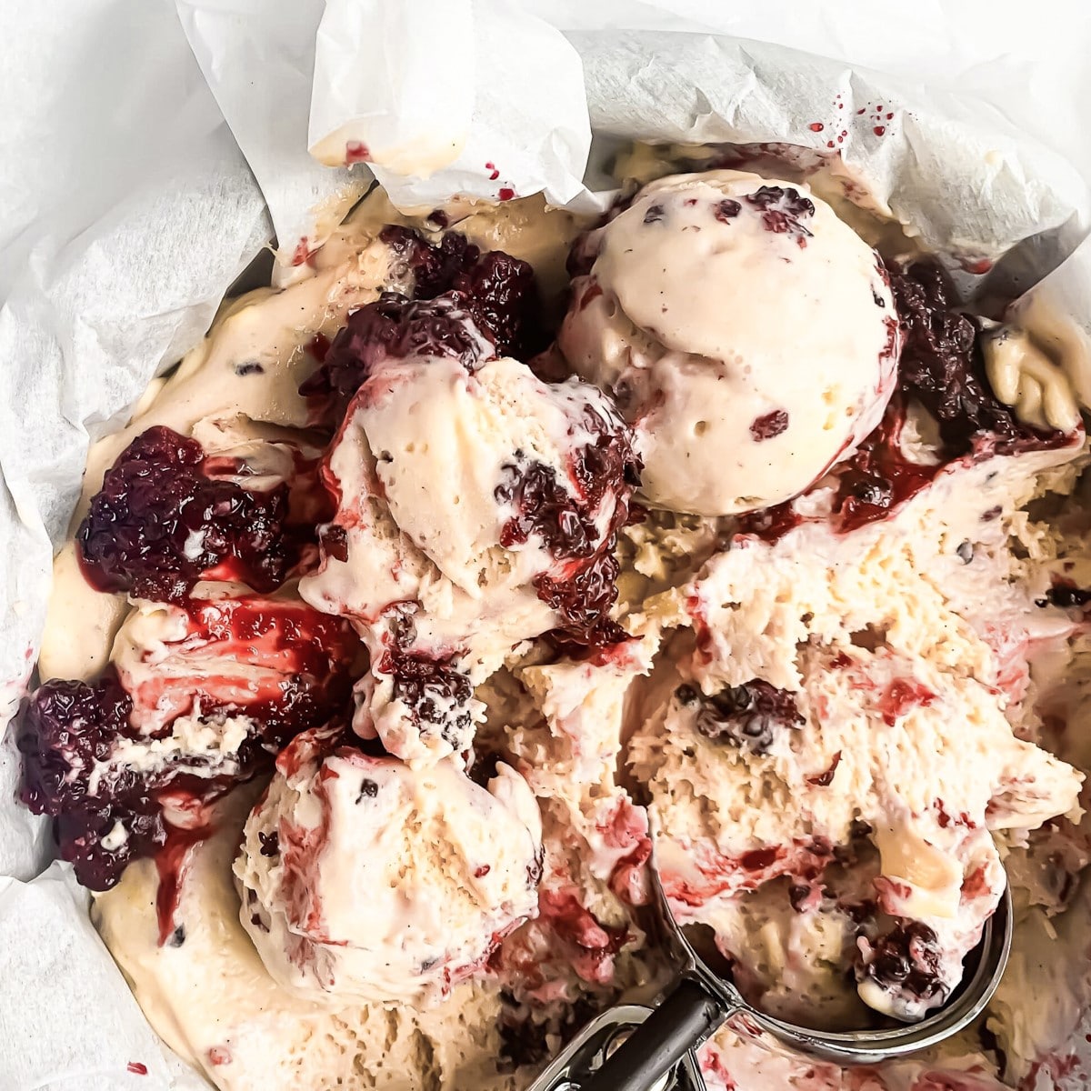 Homemade lemon curd ice cream recipe with a custard base and a blackberry syrup swirl