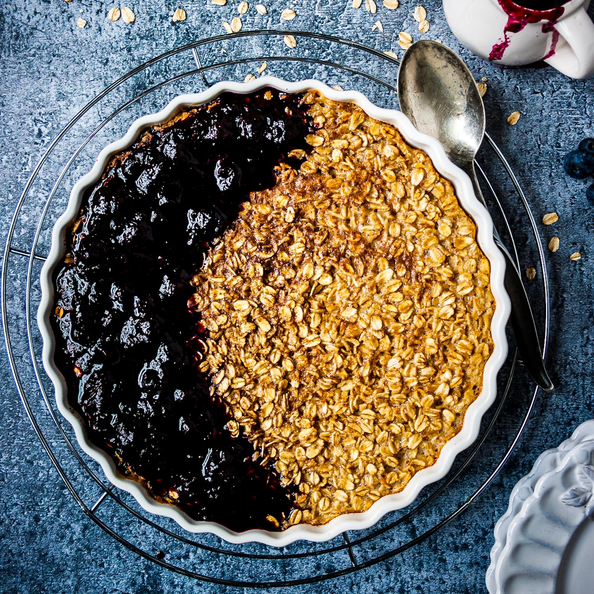 Overhead view of baked oatmeal with blueberry compote