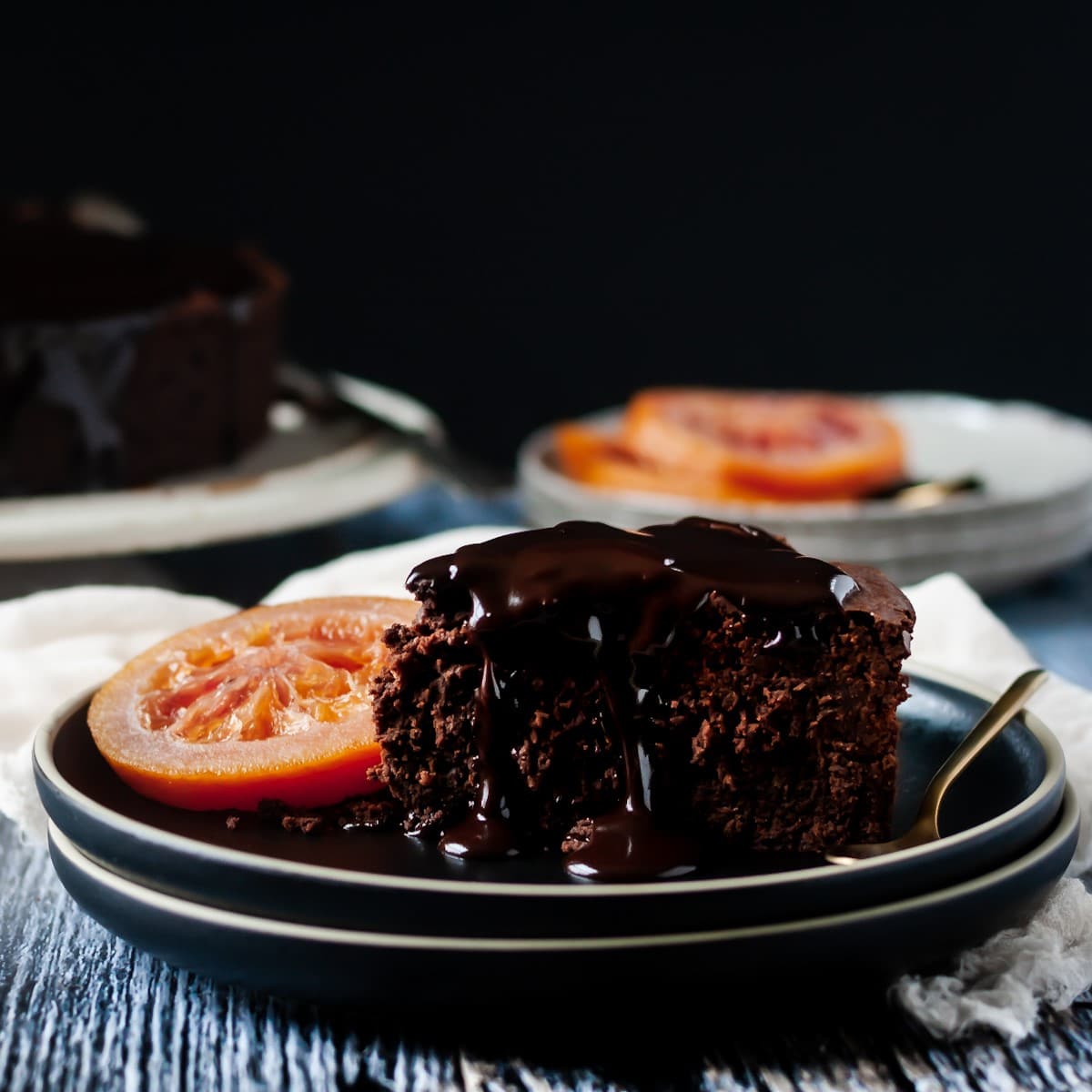 Front view of a slice of blood orange chocolate cake.