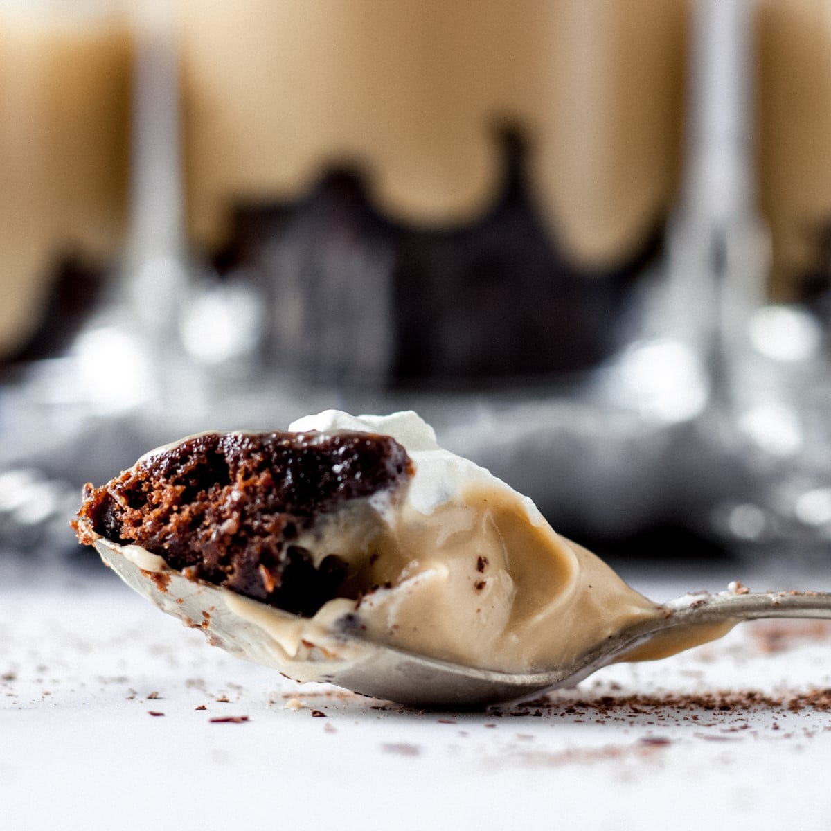 Spoonful of butterscotch pudding parfait with chocolate brownie.