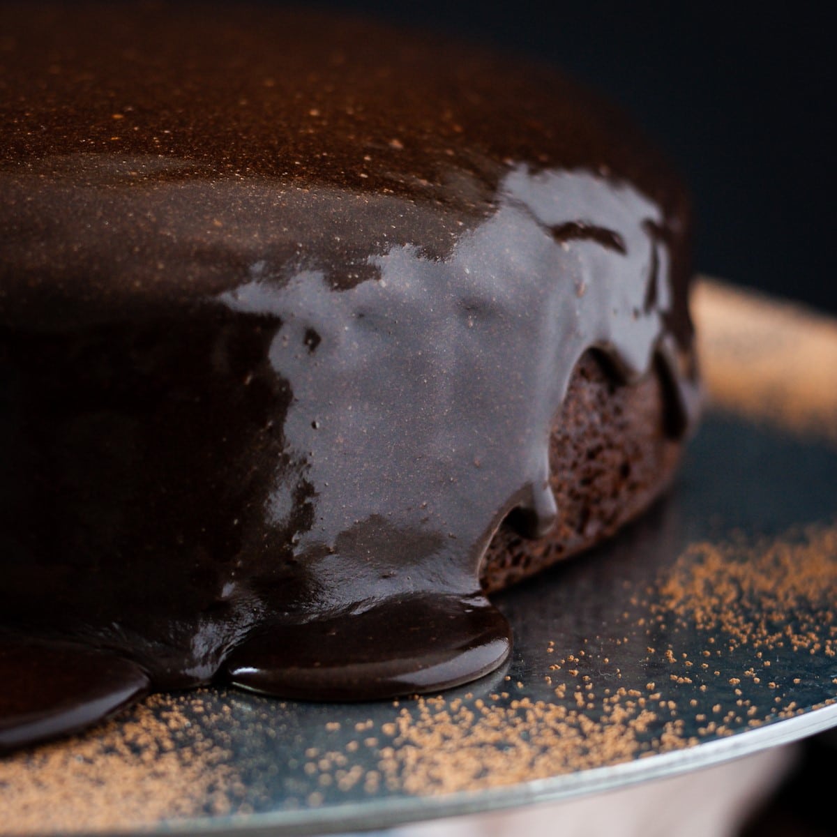 Closeup of ganache drizzle down a chocolate brownie cake