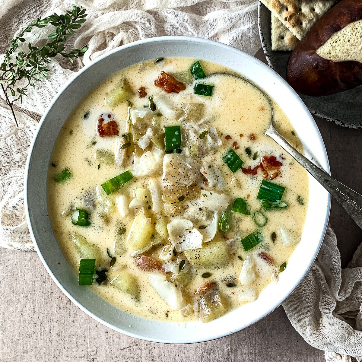 overhead view of a bowl of irish seafodd chowder with a spoon.