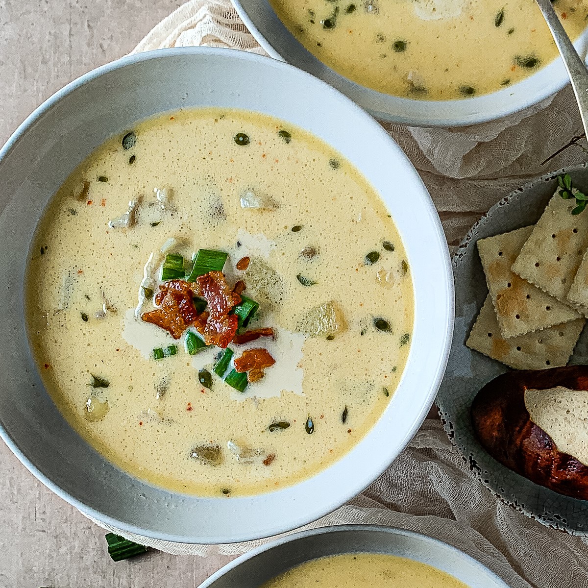 Closeup of a bowl of fish chowder with bacon sprinkled on top