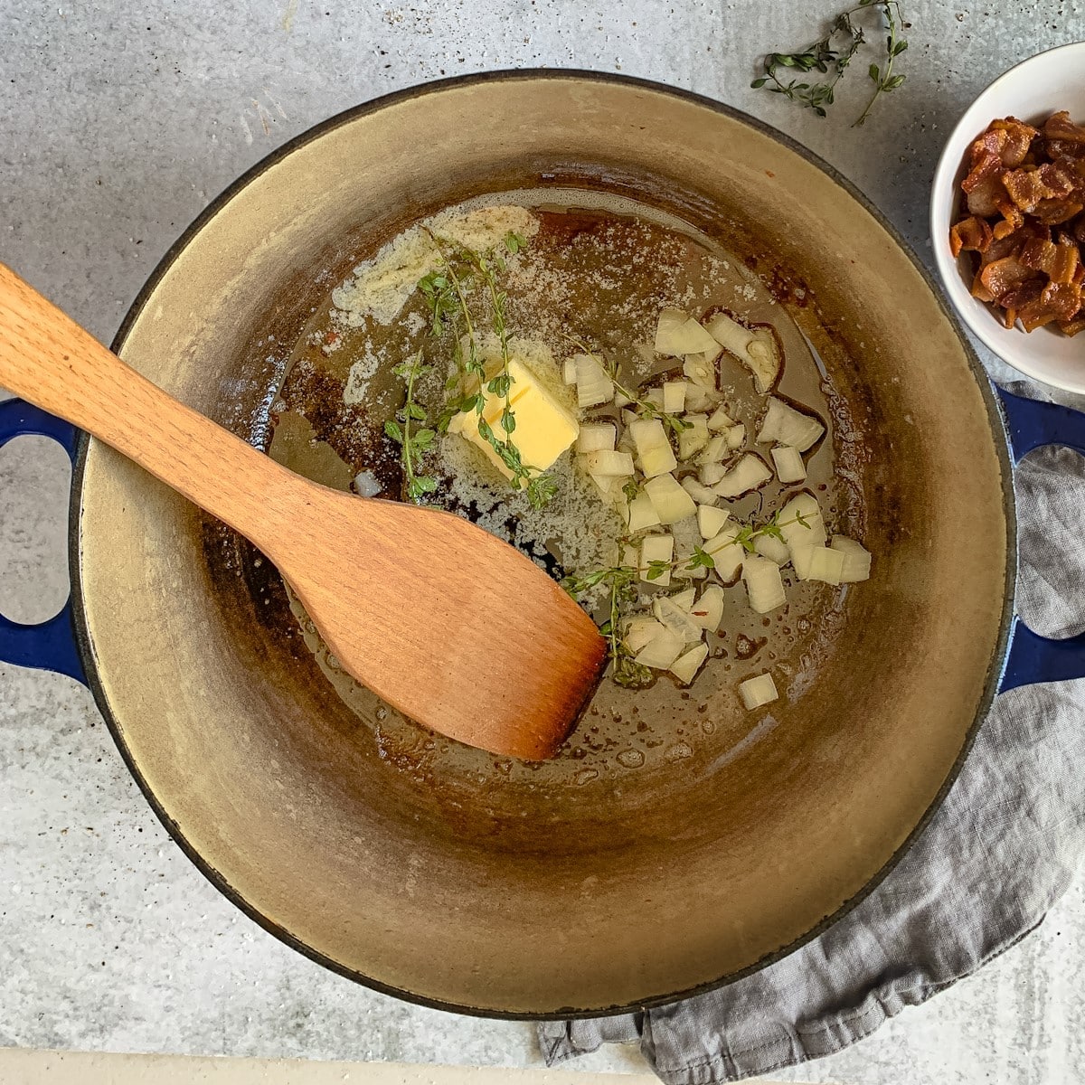 Onions and thyme cooking in a large soup pot