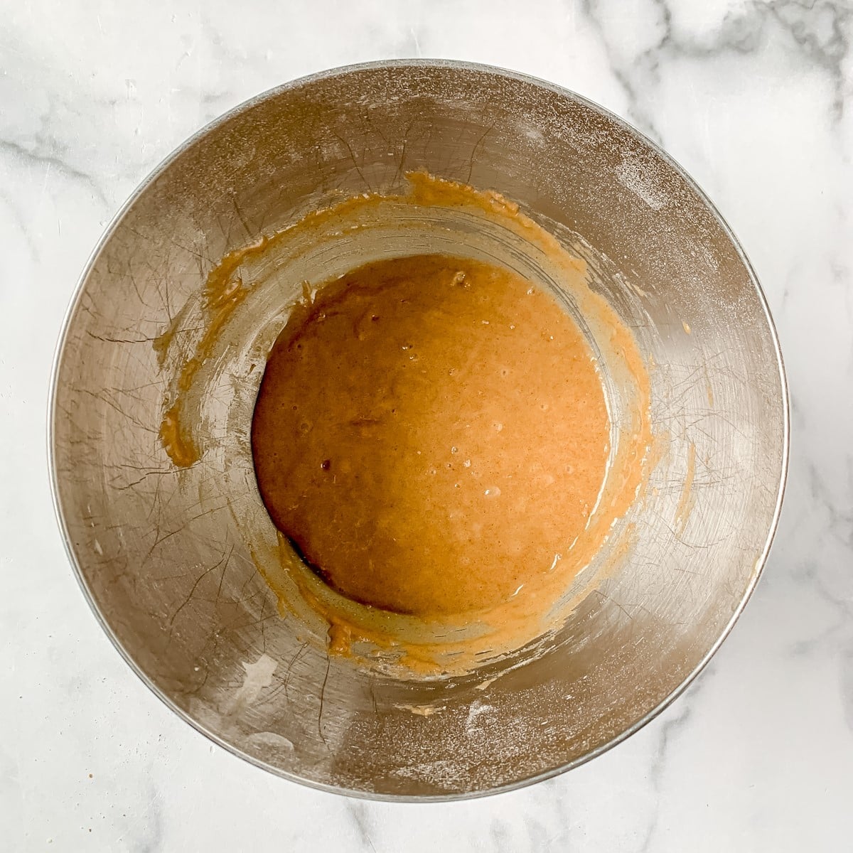 Cake batter in a metal bowl.