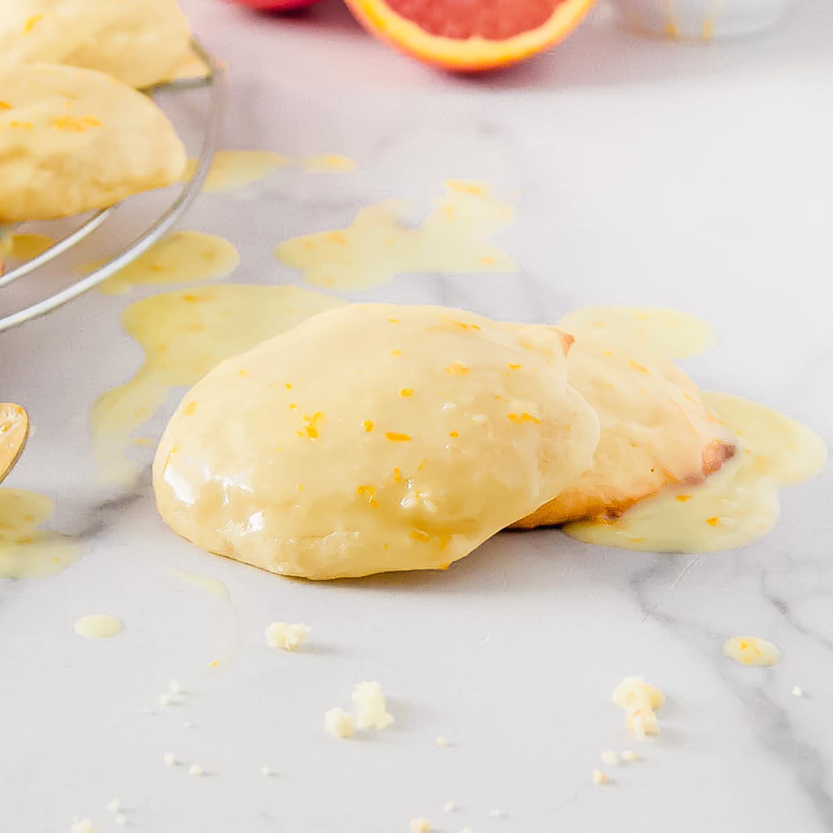 Two orange glazed orange cookies stacked on top of eachother.